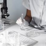 close-up-scientist-holding-glassware